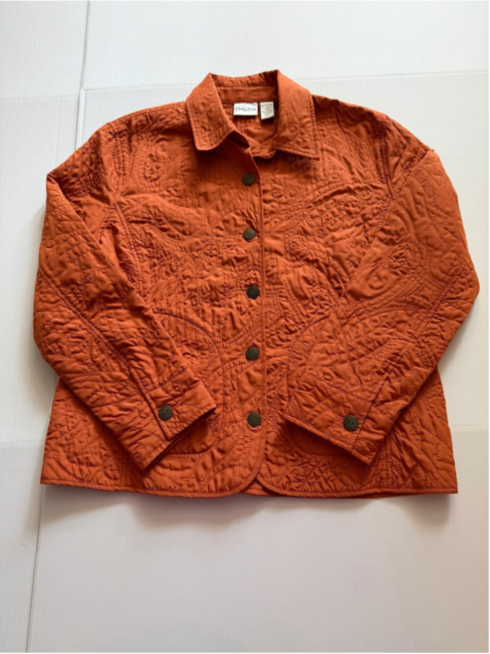 Chico's burnt orange button-up jacket featuring allover tonal paisley quilting